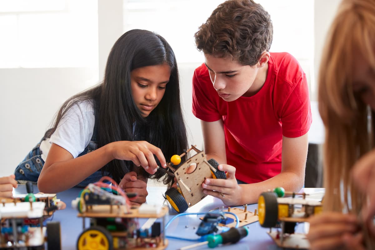 Students collaborating on building a robotics project